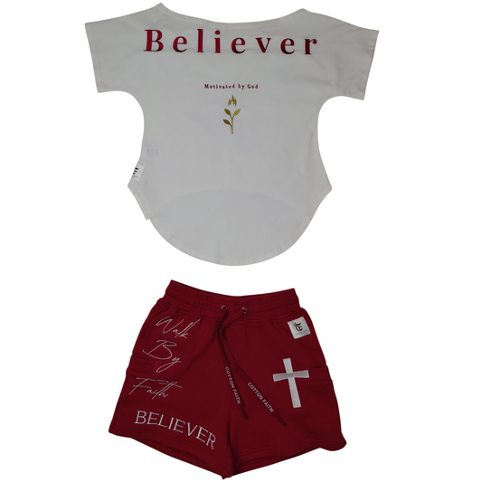 Back of white ‘Believer’ shirt with gold graphic, and front of red shorts with cross and faith-inspired text.
