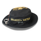 Front close-up of the “Grounded & Rooted” black bucket hat by Cotton Faith, embroidered with gold lettering and the scripture “Seed Faith, Matt. 17:20,” with a chrome seed tag accessory on the brim.