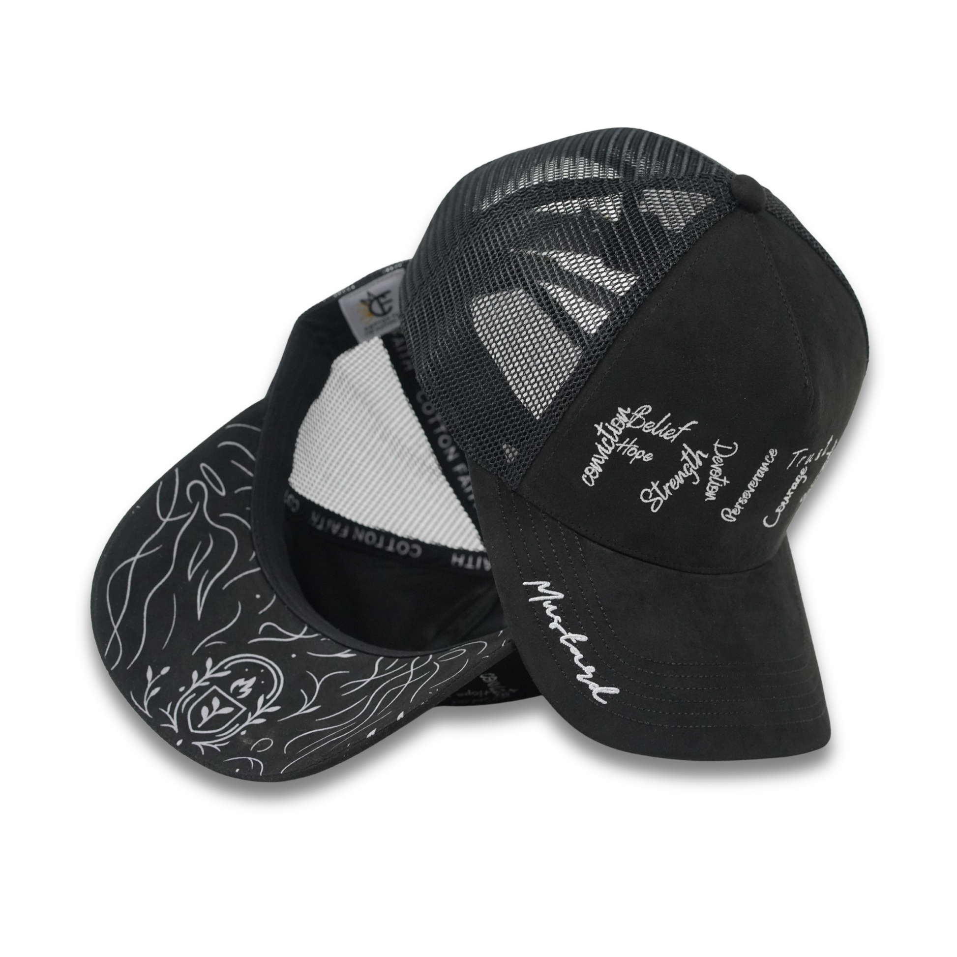 Mustard Faith suede hats one standing upright to show white embroidered faith-based words and the “Mustard” script on the brim, the other revealing the underbrim angel graphic and interior Cotton Faith branding.